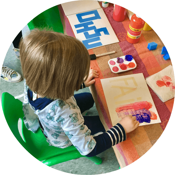 overhead view of a child painting at a Creations for Cures art hour