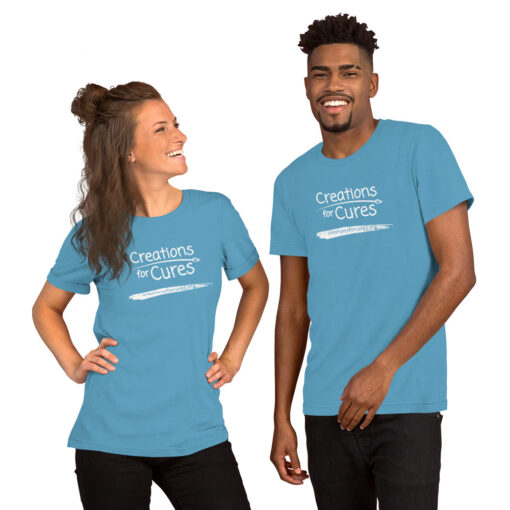 two people wearing ocean blue t-shirts featuring the Creations for Cures logo in white
