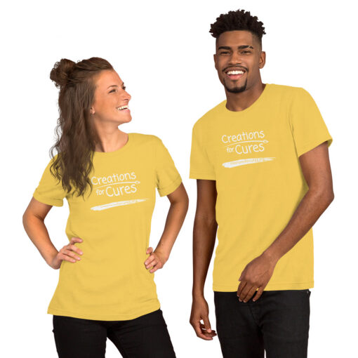 two people wearing yellow t-shirts featuring the Creations for Cures logo in white