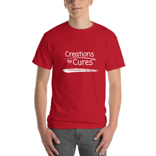 a person wearing a cherry red t-shirt featuring the Creations for Cures logo in white