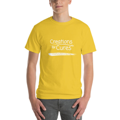 a person wearing a daisy yellow t-shirt featuring the Creations for Cures logo in white