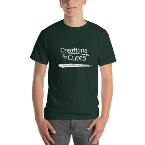 a person wearing a forest green t-shirt featuring the Creations for Cures logo in white