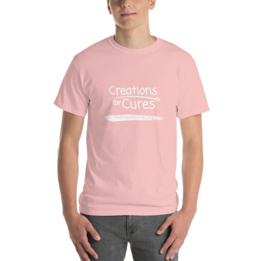 a person wearing a light pink t-shirt featuring the Creations for Cures logo in white