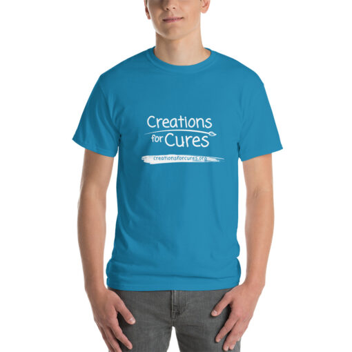 a person wearing a sapphire blue t-shirt featuring the Creations for Cures logo in white