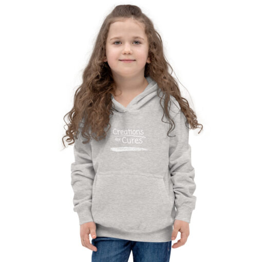 a person wearing a kids size heather grey hoodie featuring the Creations for Cures logo