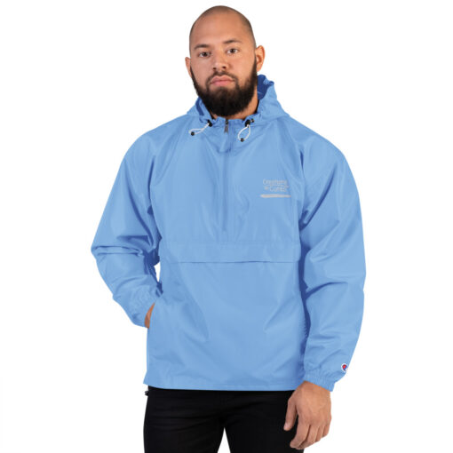 a person wearing a sky blue Champion pullover jacket with the Creations for Cures logo on it