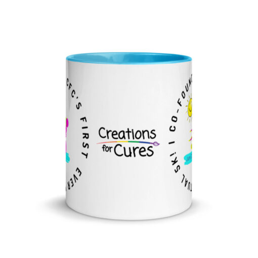 a white ceramic mug with blue interior with the Creations for Cures logo on it