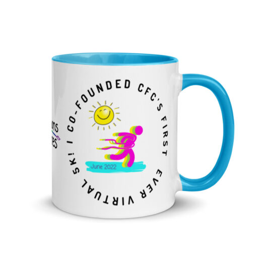 a white ceramic mug with blue handle and interior with artwork saying "I co-founded CFC's first ever virtual 5k!"
