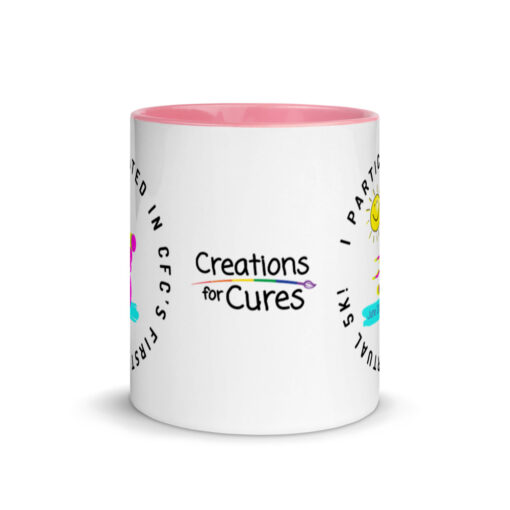 a white ceramic mug with pink interior with the Creations for Cures logo on it