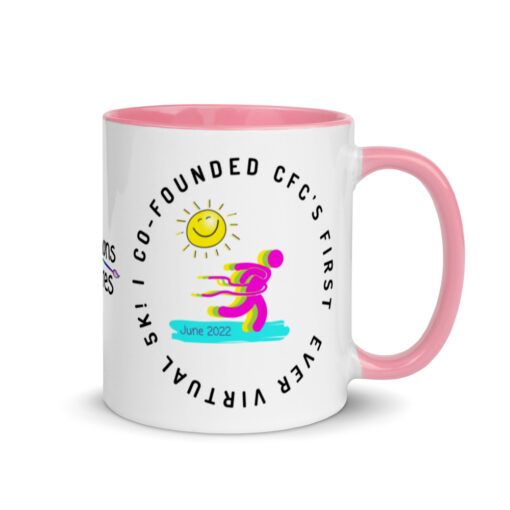 a white ceramic mug with pink handle and interior with artwork saying "I co-founded CFC's first ever virtual 5k!"