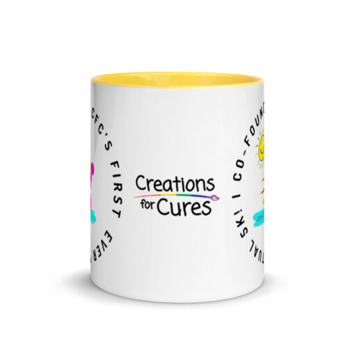 a white ceramic mug with yellow interior with the Creations for Cures logo on it